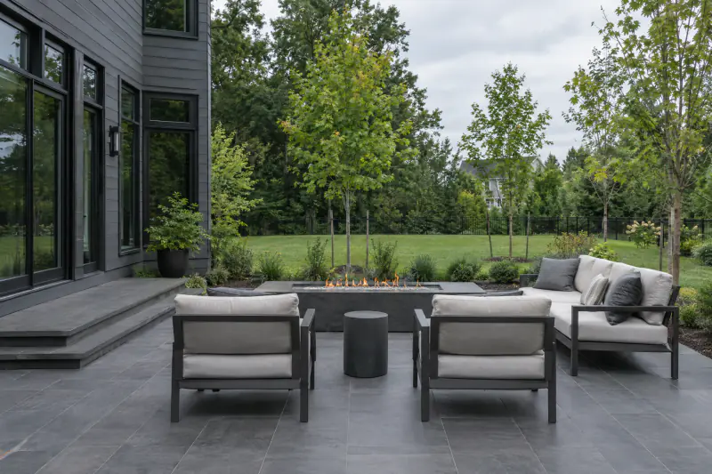 Large format charcoal porcelain pavers on a modern Northern Virginia home patio with a linear fire feature