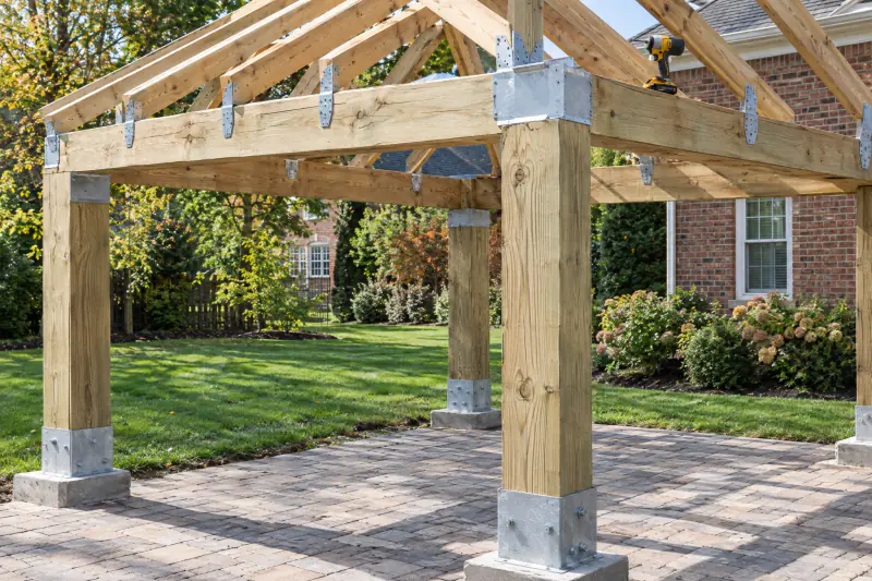 Galvanized hurricane ties and post cap connectors on a pavilion roof frame under construction in a Northern Virginia backyard