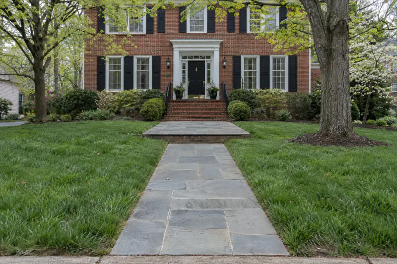 Straight bluestone front walk with a wide landing leading to the centered door of a symmetrical colonial in Northern Virginia