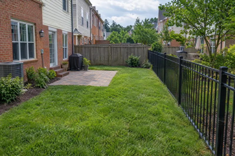 Six-foot privacy fence meeting a four-foot picket fence at a Northern Virginia townhome rear yard