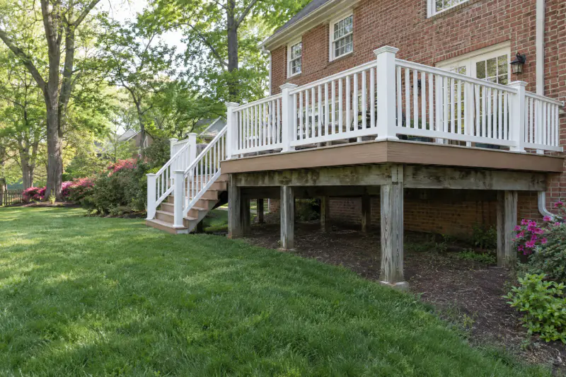 Resurfaced deck with new composite boards and railing on an older wood frame