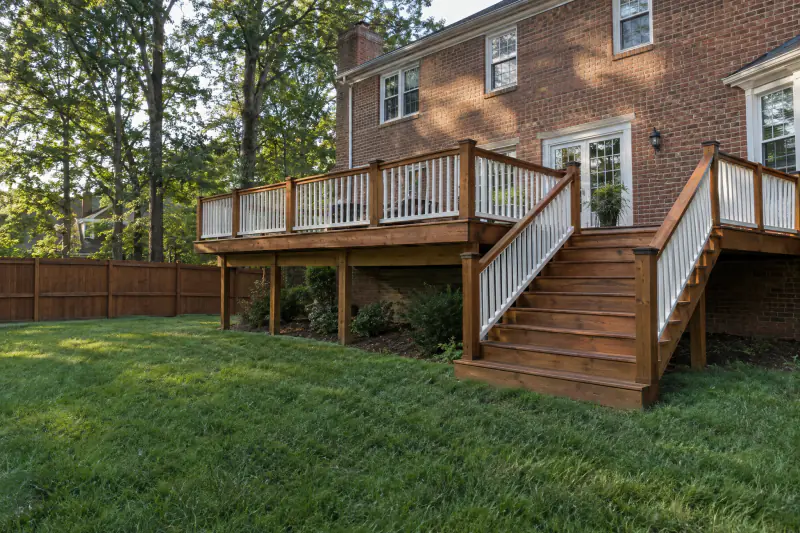 Freshly stained wood deck and privacy fence after deck cleaning and staining